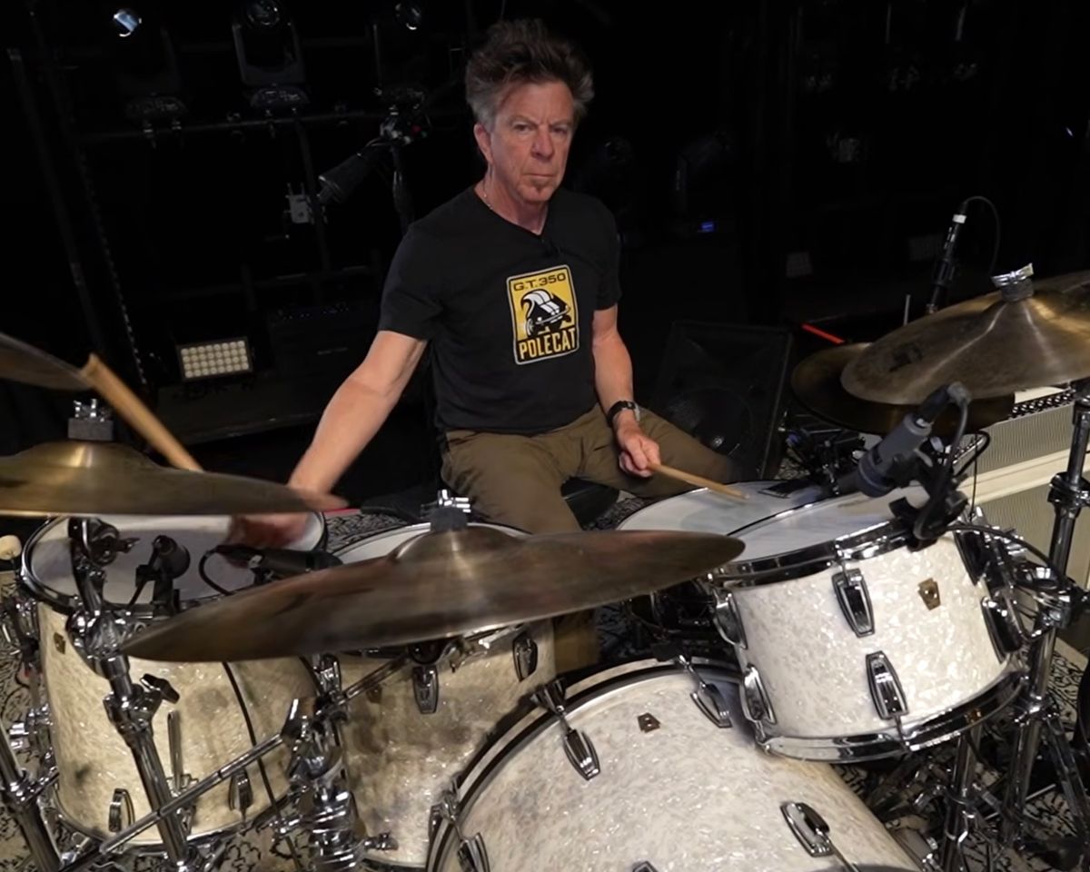 Chris Layton drumming, wearing the Polecat shirt
